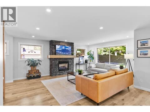 Gas fireplace and vinyl plank floors at 905 Paret Crescent, Lower Mission, Kelowna