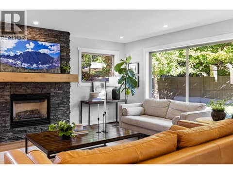 Gas fireplace and vinyl plank floors at 905 Paret Crescent, Lower Mission, Kelowna