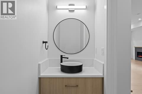 Powder room on main floor. Photo of opposite side unit at 662 Birch Avenue Unit# 4, Kelowna South