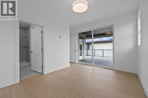 Primary suite walk out to rooftop deck. Photo of opposite side unit at 662 Birch Avenue Unit# 4, Kelowna South