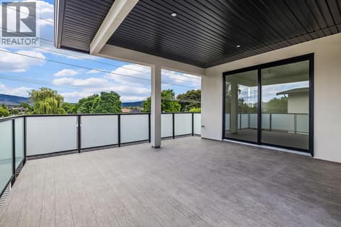 Rooftop patio off primary suite. Photo of opposite side unit at 662 Birch Avenue Unit# 4, Kelowna South
