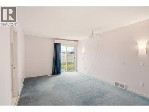 Main floor primary bedroom with ensuite and private patio. at 756 Springrose Way, Lower Mission, Kelowna