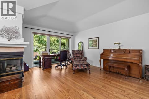 Living Room with Fireplace and Patio Access at 3889 Gallaghers Grange, South East Kelowna