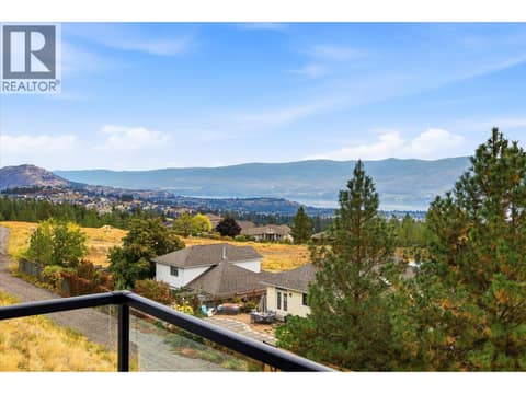 Morning coffees on the cozy balcony will never get old here! at 2815 Copper Ridge Drive, Smith Creek, West Kelowna