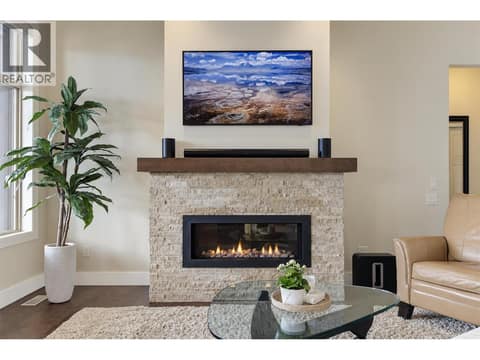 Frame TV professionally mounted above the fireplace. at 2151 Madera Court, Westbank Centre, West Kelowna