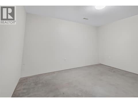 Additional flex room provides valuable extra storage or the opportunity to create a home gym, workshop, hobby room, or office. at 330 Woodwind Court, Glenmore, Kelowna