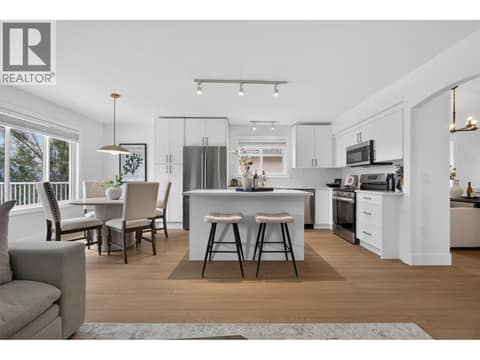 Brand-new kitchen featuring modern cabinetry, new countertops and appliances, and a island with seating that creates a natural gathering place. at 330 Woodwind Court, Glenmore, Kelowna