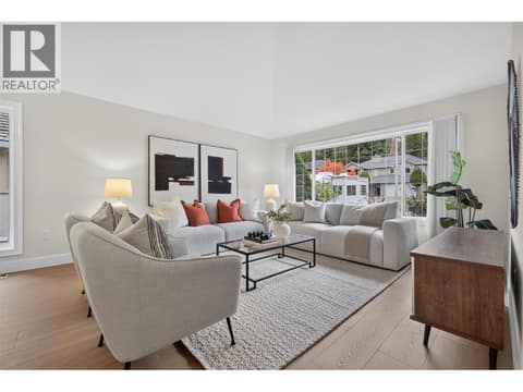 Bright and inviting living room with vaulted ceilings, large windows, and an abundance of natural light creating an open and spacious feel. at 330 Woodwind Court, Glenmore, Kelowna