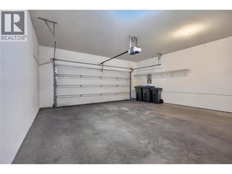 Spacious double-car garage provides plenty of room for vehicles, storage, and all your Okanagan gear. at 330 Woodwind Court, Glenmore, Kelowna