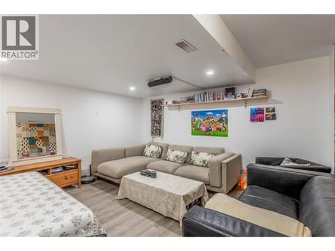 Lower level flex/media room. Utility room access through here and joining door to legal suite can be left closed, or open for larger families wanting to stay connected. at 705 Stoltz Court, Rutland North, Kelowna