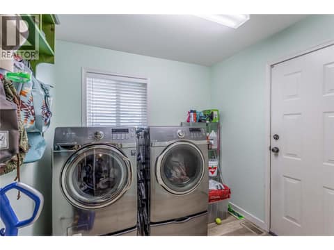 Main Floor laundry. Garage access from this room at 705 Stoltz Court, Rutland North, Kelowna