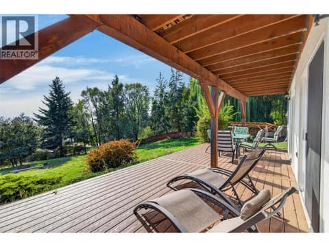 Covered lower deck offering plenty of space to relax, entertain, and enjoy the private yard. at 359 Kildare Way, Okanagan North, Vernon