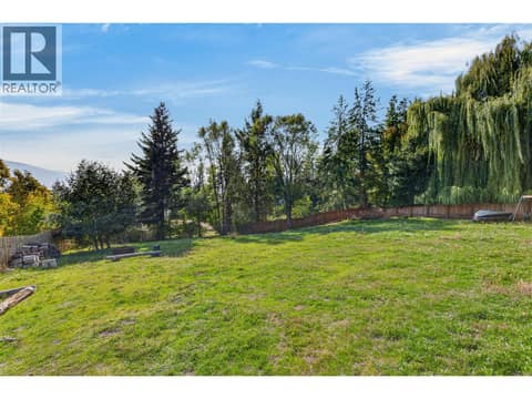 Expansive fully fenced backyard with mature trees and plenty of room to enjoy the outdoors. at 359 Kildare Way, Okanagan North, Vernon