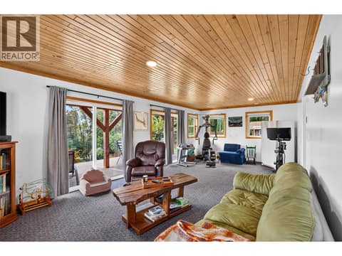 Spacious lower level recreation room with walkout access to the yard and plenty of room for relaxing, fitness, or play. at 359 Kildare Way, Okanagan North, Vernon