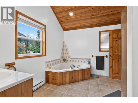 Spacious main bathroom with vaulted wood ceiling, jetted tub, separate shower, and plenty of natural light. at 359 Kildare Way, Okanagan North, Vernon