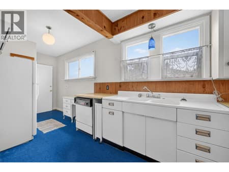 Kitchen with original steel sink at 879 Trench Court, Kelowna North