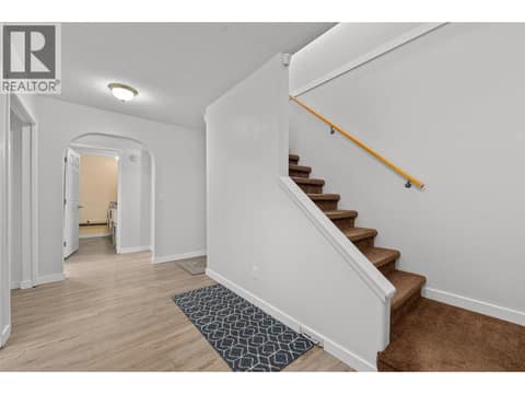 Foyer | Lower Level - With new laminate flooring through out the lower level at 3220 McIver Road, Glenrosa, West Kelowna