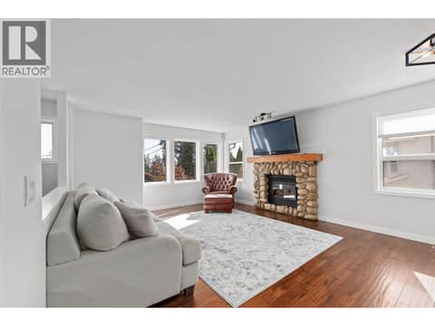 Living Room | Main Level - with large windows & gas fireplace at 3220 McIver Road, Glenrosa, West Kelowna