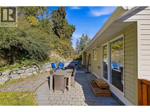 Patio & Backyard Space | Main Level - Extensively updated landscaping with lawn, fencing, & tree removal. at 3220 McIver Road, Glenrosa, West Kelowna