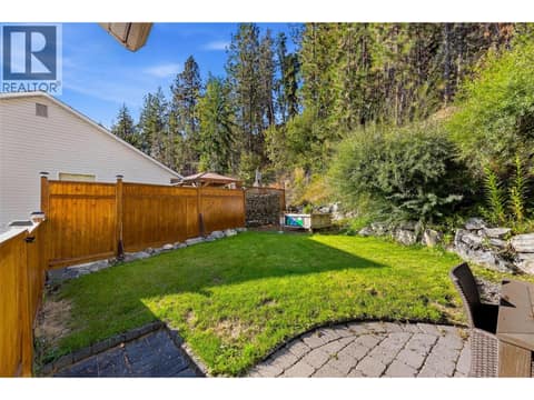 Patio & Backyard Space | Main Level - Extensively updated landscaping with lawn, fencing, & tree removal. at 3220 McIver Road, Glenrosa, West Kelowna