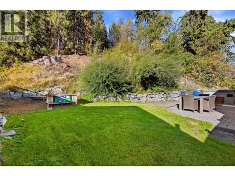 Patio & Backyard Space | Main Level - Extensively updated landscaping with lawn, fencing, & tree removal. at 3220 McIver Road, Glenrosa, West Kelowna