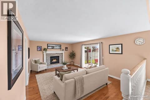 Family room with virtually staged furnishings at 884 Mission Springs Crescent, Lower Mission, Kelowna