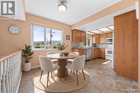 Kitchen with breakfast area, virtually staged furnishings. at 884 Mission Springs Crescent, Lower Mission, Kelowna