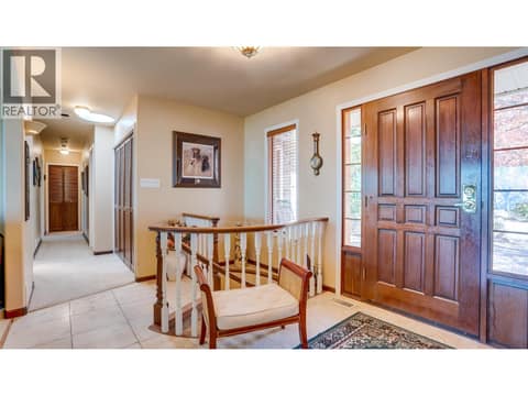 Foyer with the spiral staircase to the lower level. at 3200 Greenwood Road, South BX, Vernon