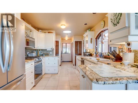 Kitchen has granite counters, a gas range and Italian cabinetry. at 3200 Greenwood Road, South BX, Vernon
