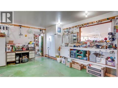 The main garage beside the breezeway is oversized, parks 2 vehicles and has a separate workshop at the back. at 3200 Greenwood Road, South BX, Vernon