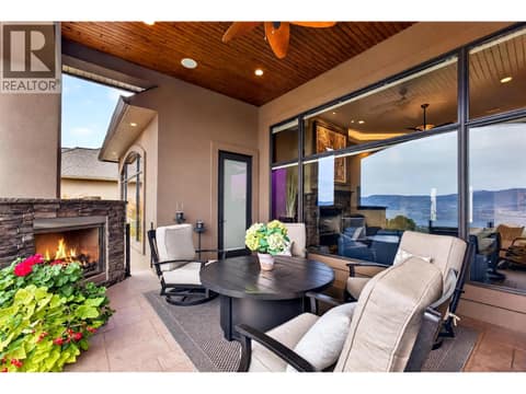 Large wrap-around patio with fireplace & outdoor fan at 734 Marin Crescent, Upper Mission, Kelowna