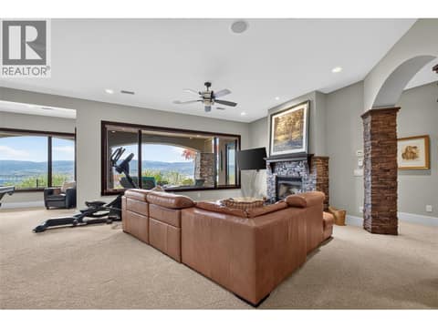 Room is anchored by a fireplace at 734 Marin Crescent, Upper Mission, Kelowna