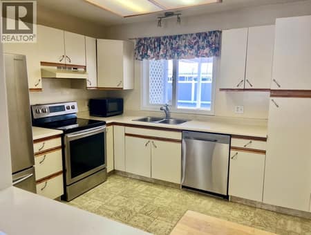 Kitchen faces South and looks out onto carport area at 3900 27 Avenue Unit# 74, Westmount, Vernon