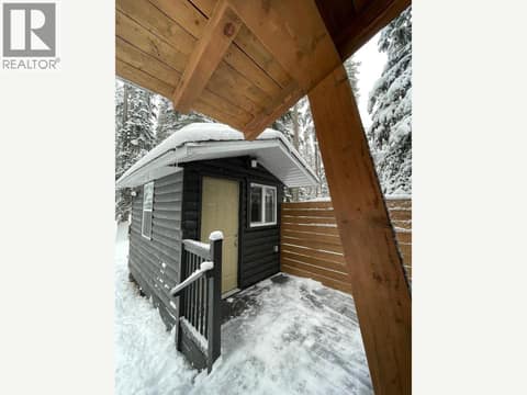 Covered walkway overlooking the detached outbuilding at 1166 Apex Mountain Road, Penticton Apex