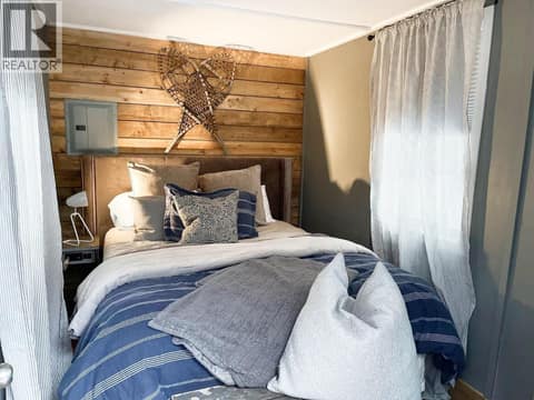 Detached bunkie interior with wood feature wall and windows at 1166 Apex Mountain Road, Penticton Apex
