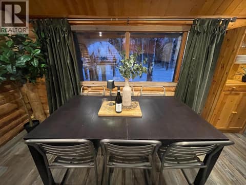 Dining table beneath a large window at 1166 Apex Mountain Road, Penticton Apex