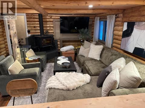 Elevated view over the living room and wood stove at 1166 Apex Mountain Road, Penticton Apex