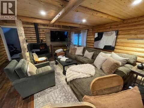 Open living area with sectional seating and breakfast bar at 1166 Apex Mountain Road, Penticton Apex