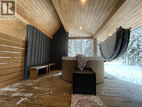 Outdoor spa beneath a wood-clad covered deck at 1166 Apex Mountain Road, Penticton Apex