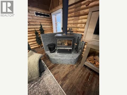 Wood-burning stove on a raised hearth at 1166 Apex Mountain Road, Penticton Apex