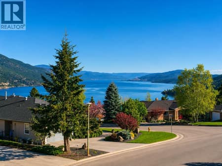 Located in prestigious Magic Estates, this 4 bedroom, 3 bathroom home with two flex rooms showcases stunning views of Okanagan Lake and the surrounding mountains. at 183 Magic Drive, Glenmore, Kelowna