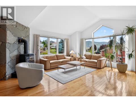 Oversized windows fill the home with natural light and frame spectacular views throughout. at 183 Magic Drive, Glenmore, Kelowna