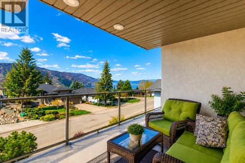 The covered front balcony is perfect for relaxing. at 183 Magic Drive, Glenmore, Kelowna