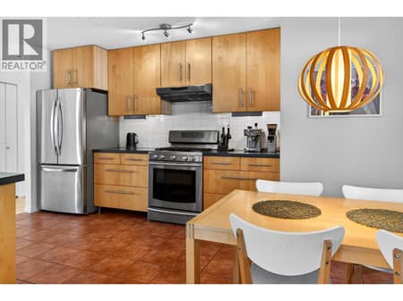 The kitchen offers ample counter space, a gas range, and breakfast area. at 183 Magic Drive, Glenmore, Kelowna