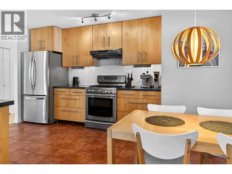 The kitchen offers ample counter space, a gas range, and breakfast area. at 183 Magic Drive, Glenmore, Kelowna