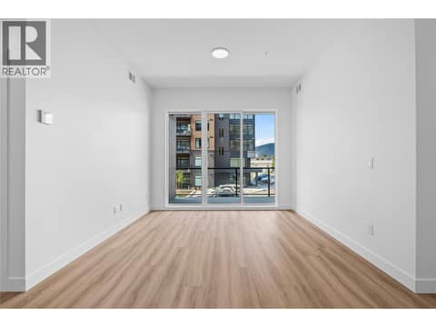Living Room with Patio Access - Photos of a similar home in the community. at 2760 Olalla Road Unit# 208, Lakeview Heights, West Kelowna