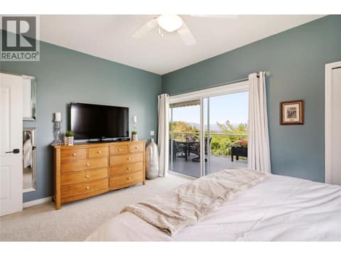 Primary bedroom with new sliding doors to the patio at 724 Lone Pine Drive, Black Mountain, Kelowna