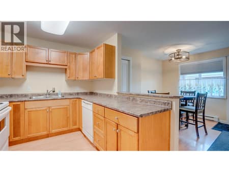 Kitchen facing dining area at 4740 20 Street Unit# 99, Harwood, Vernon
