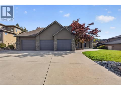 A triple-car garage, RV parking, and plenty of additional driveway space for vehicles and recreational toys. at 2512 Selkirk Drive, Dilworth Mountain, Kelowna
