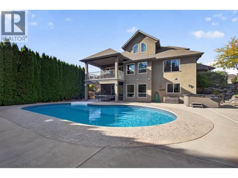 Private backyard showcasing the spacious family home, heated inground pool, and outdoor living areas, perfect for entertaining and enjoying Okanagan summers. at 2512 Selkirk Drive, Dilworth Mountain, Kelowna